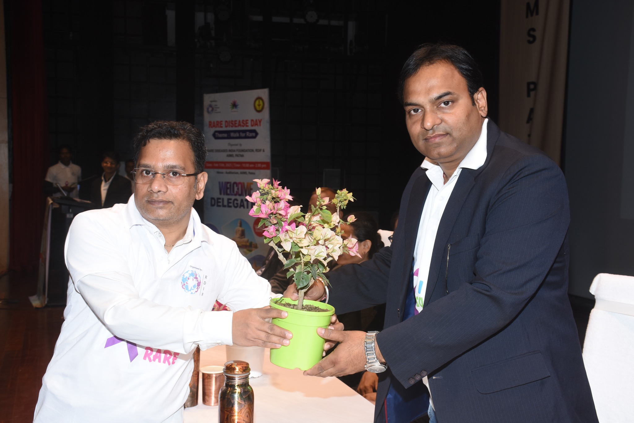 A researcher explaining a poster presentation.